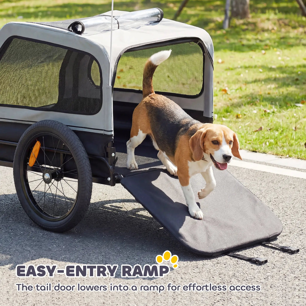 Remorque vélo pour chien, adaptée aux chiens de petite et moyenne taille jusqu'à 20 kg, avec attelage universel et hayon à rampe rabattable, couleur grise.